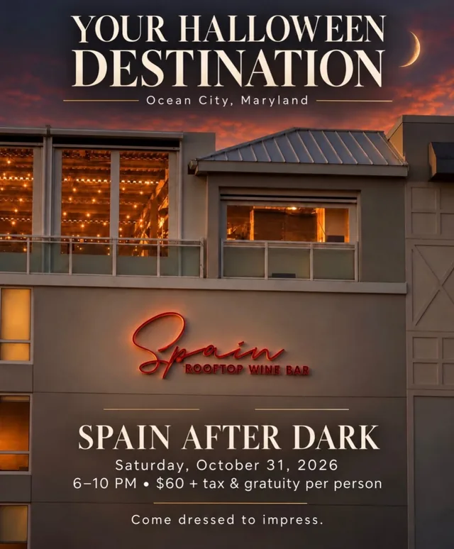Your Halloween Destination: the Cambria Hotel at dusk with the red Spain Rooftop Wine Bar sign. Spain After Dark, Saturday, October 31, 2026, 6 to 10 PM.