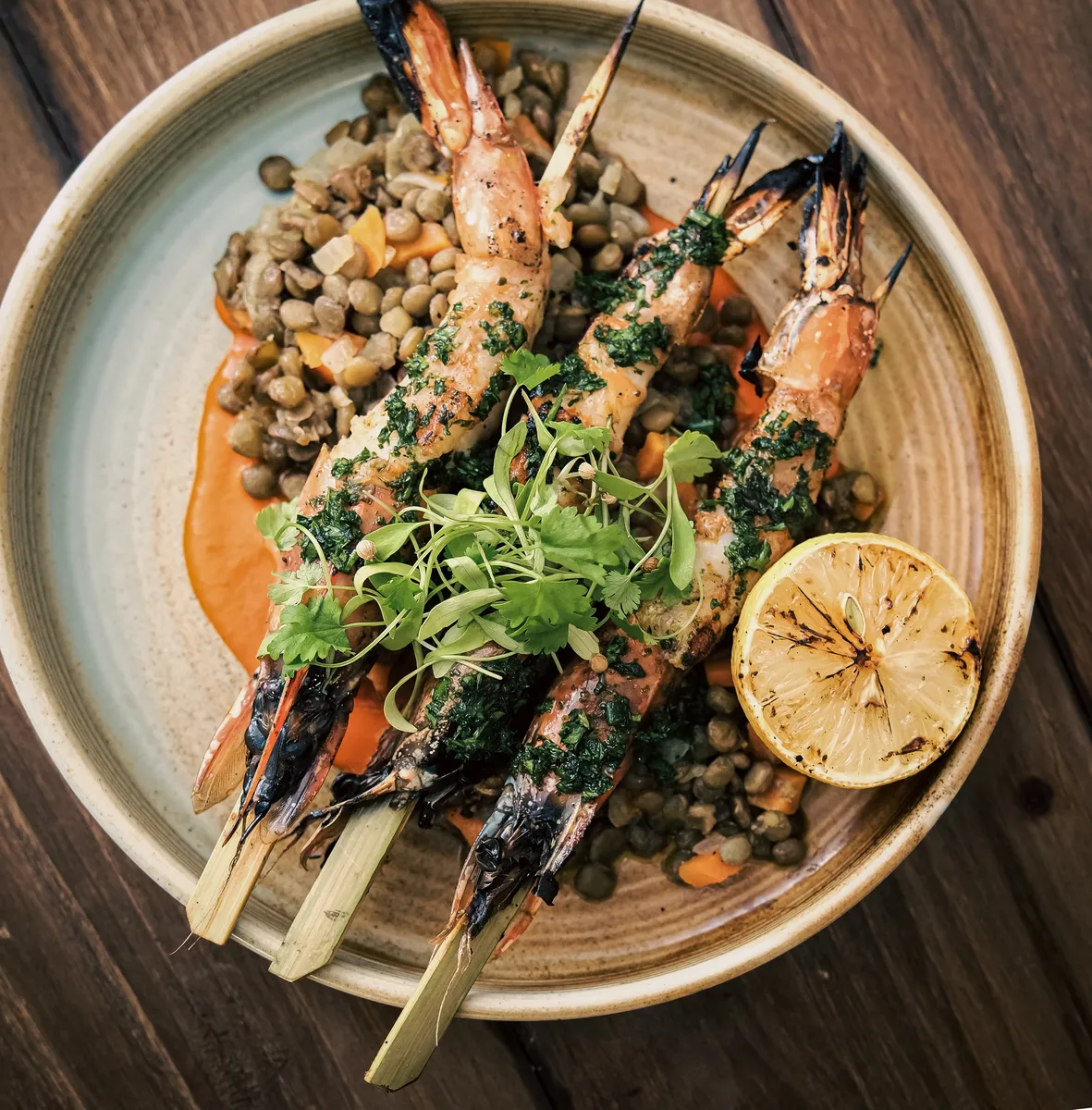 Grilled prawns and lentils with charred lemon